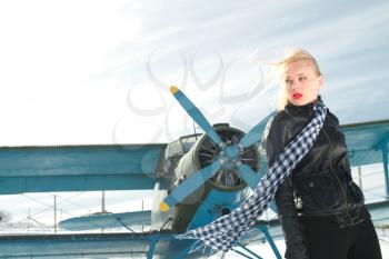 sexy young girl next to the pilot vintage aircraft

