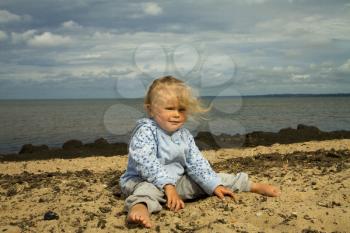 little girl sat in the twine . summer vacation by the ocean