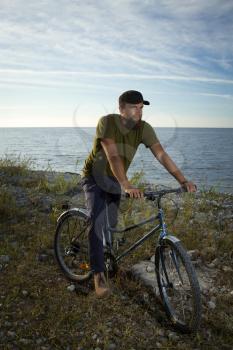 man on a bicycle near the sea. Travel and Recreation summer