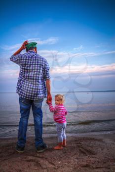 Dad with his little daughter at the sea