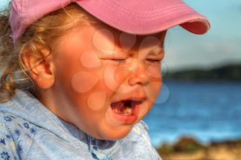 little girl weeping by the sea. summer vacation by the ocean