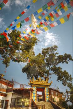 Swayambhunath monk sitting on the steps of the temple. Nepal. Asia architecture.