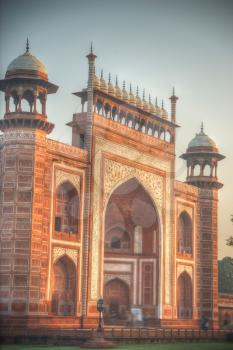 gate through which the Taj Mahal visitors in a park that surrounds the mausoleum