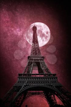 Beautiful view of famous Eiffel Tower in Paris, France. The stars and the moon shine at night.
