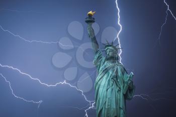 Statue of Liberty Neoclassical sculpture on Liberty Island southwest of Manhattan Island, USA. Powerful lightning strike.