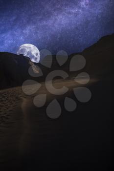 Valle de la Luna (Moon Valley) close to San Pedro de Atacama, Chile. starry sky shines at night.