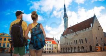 A married couple travels around Tallinn, Estonia. Very beautiful old Town Hall Square