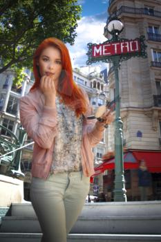 woman in Paris is standing near the subway and painting lipstick lips