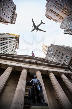 tourist plane flies over Federal Hall National Memorial on Wall Street, Lower Manhattan, New York City, USA