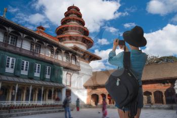 a woman tourist travels through Nepal and takes everything on the camera