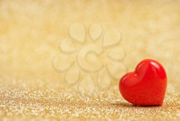 red hearts on a table, red hearts on golden background