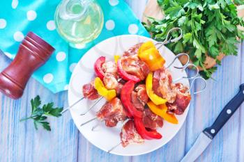 raw meat kebab with vegetables on a table