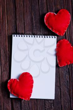 note book and hearts on the wooden table