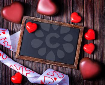 red hearts and black board on a table