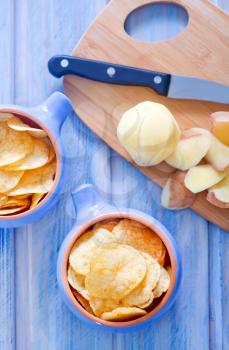potato chips in bowl and on a table