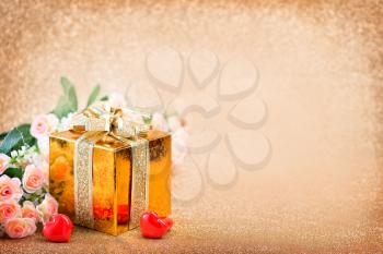 box for present and hearts on a table