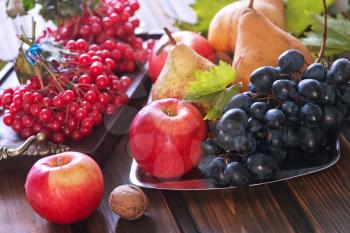 autumn fruits on the wooden table, apples and grape