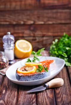 salmon with lemon and pepper on plate