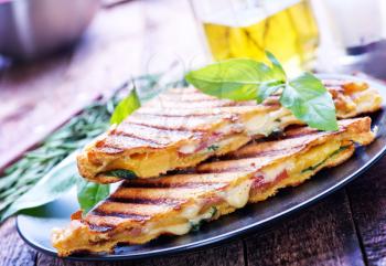toasts with cheese and ham on the plate