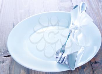 white plate, fork and knife on plate