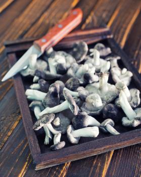 raw mushroom in the wooden box and on a table