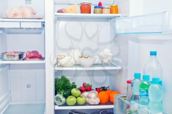 Refrigerator full of food, water in bottles