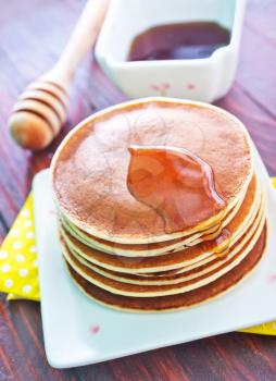 sweet pancakes with honey on the plate