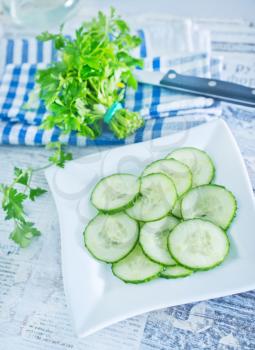 salad with cucumbers on plate and on a table