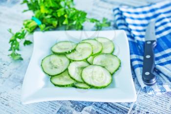 salad with cucumbers on plate and on a table