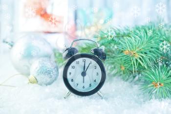 clock and christmas decoration on the snow
