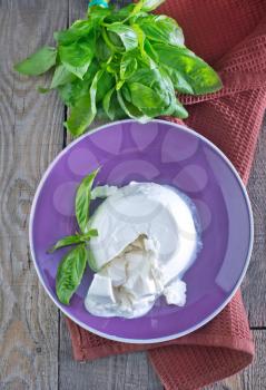 fresh ricotta with basil on the plate