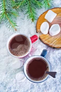 cocoa drink in red cup and on white snow