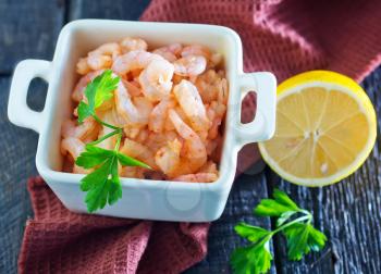 boiled shrimps and fresh lemon on a table