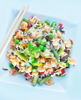 fried rice with mix vegetables on the white plate