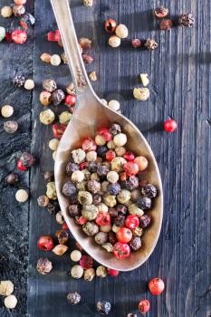 pepper mix in metal spoon and on a table