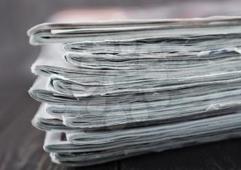 stack of magazines on the wooden table