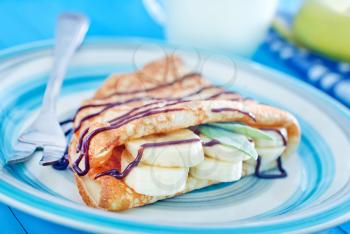pancakes with chocolate and banana on the plate