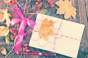 envelope on the wooden background,envelopes and autumn leaves