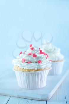 muffins with white cream on a table