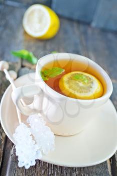 fresh tea with mint and lemon in cup