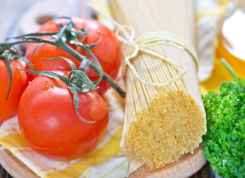 spaghetti with cheese and tomato on the wooden table