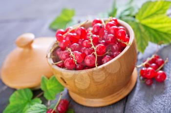 red currant in the bowl and on a table