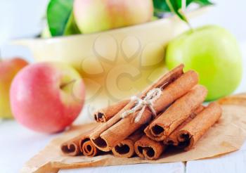 cinnamon and apples on the wooden table