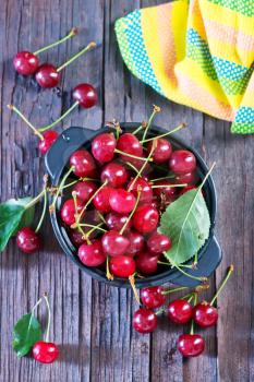 fresh cherry in bowl and on a table