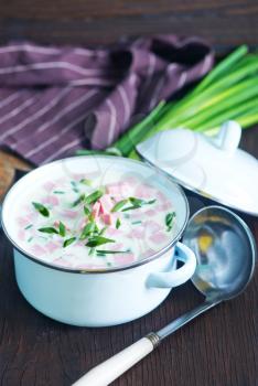 cold soup in metal bowl and on a table