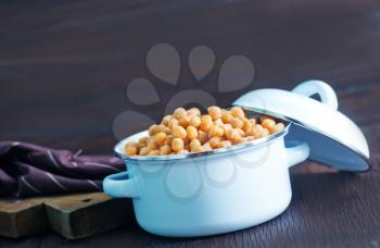 chickpeas in metal bowl and on a table