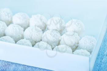 coconut balls with cream on the white table