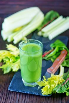 fresh vegetable juice in glass and on a table