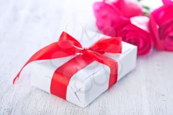 present and red rose on the white plate