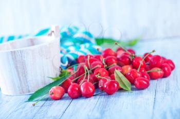 fresh cherry in white bowl and on a table